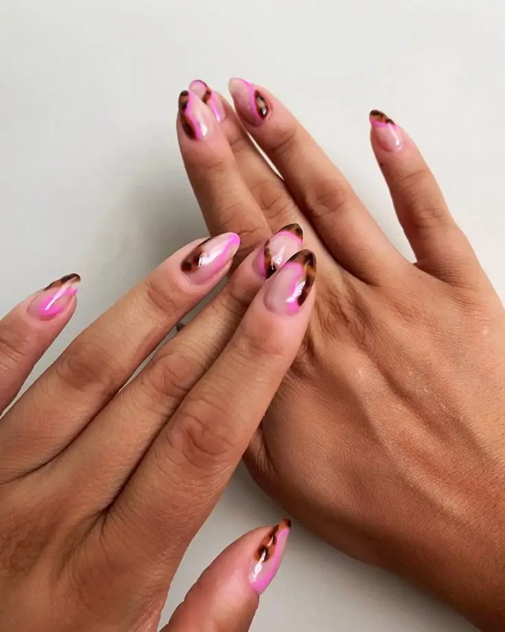 Tortoiseshell tips on pink almond nails, trendy and unique