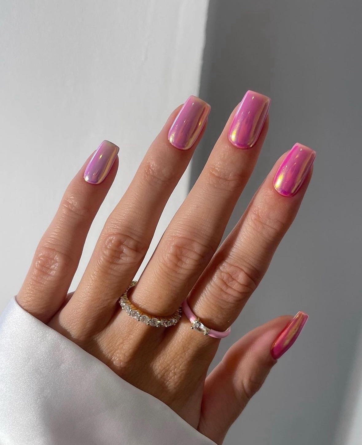 Pink chrome nails with a square shape, vibrant and glossy