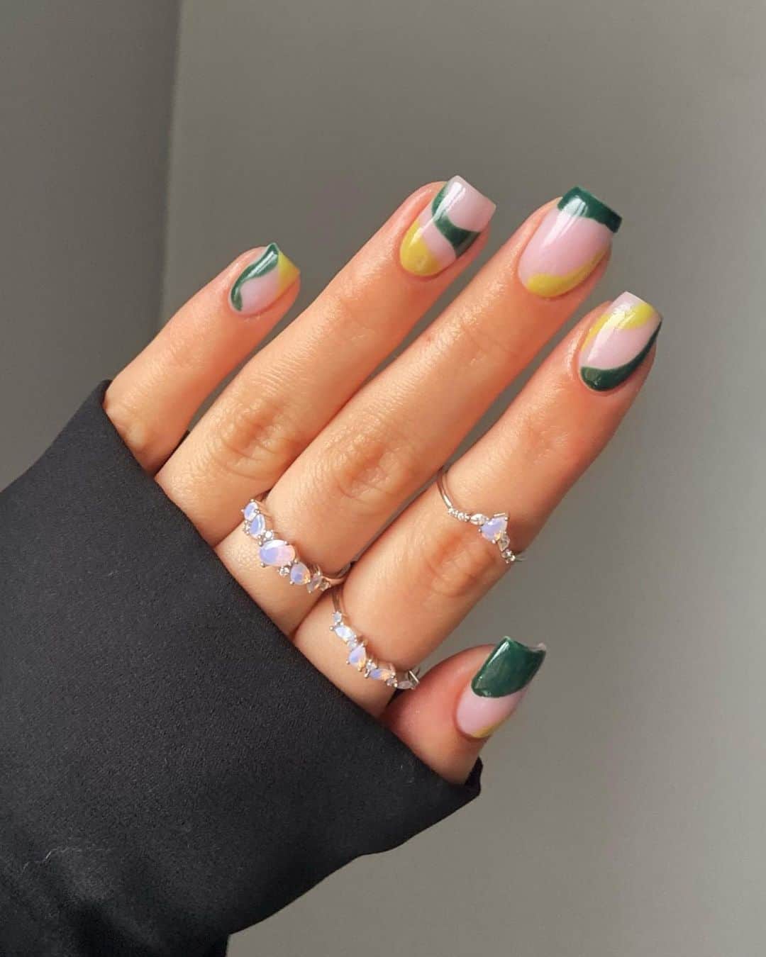 Abstract green and yellow nail art on short square nails