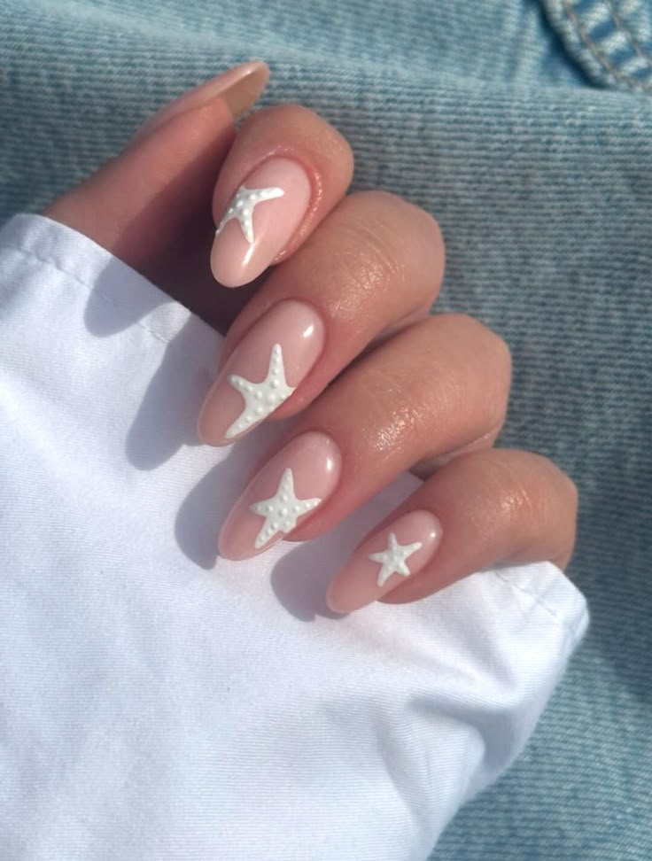 Starfish nail art on nude almond nails, perfect for beach lovers