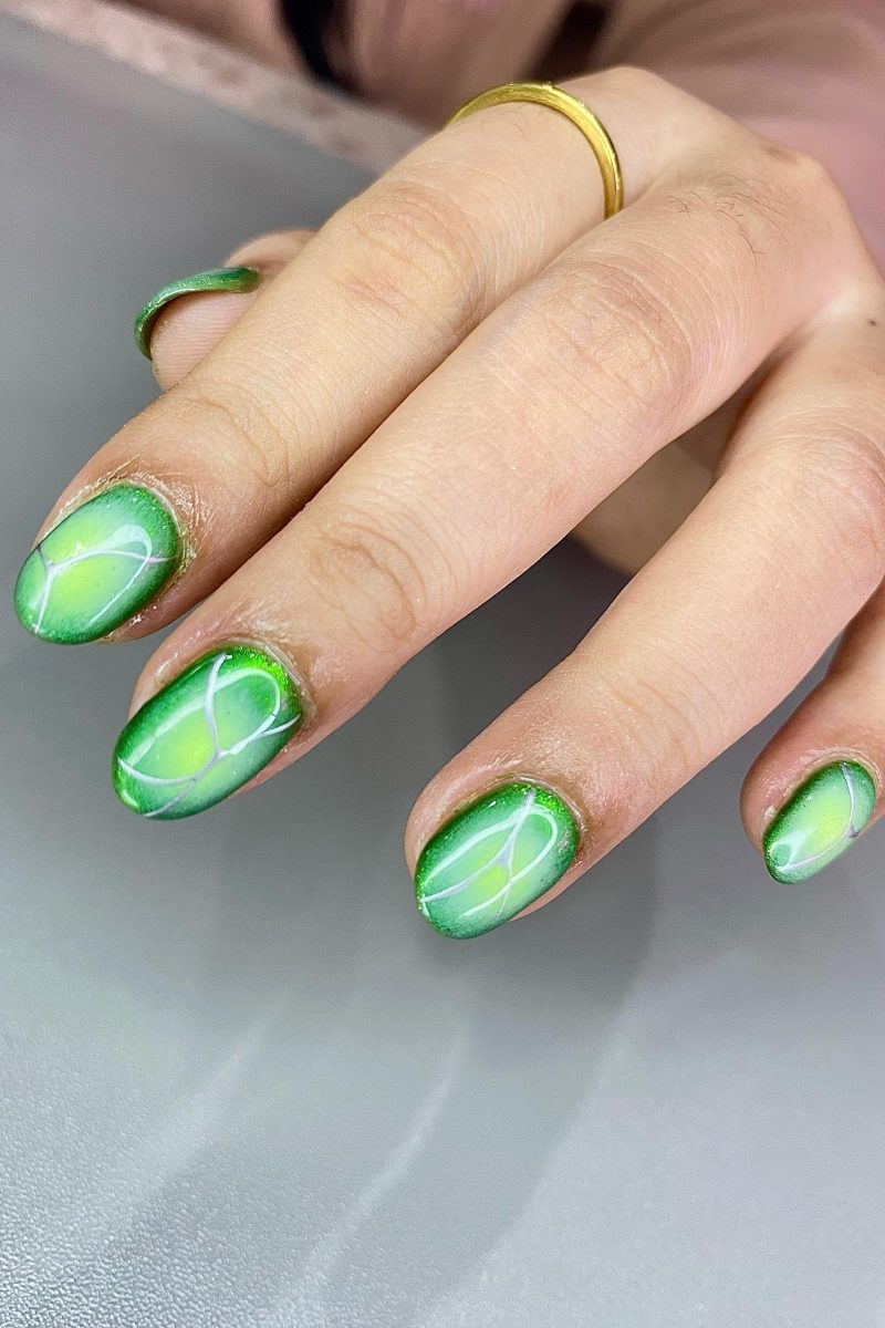 Bright green swirl nails with intricate patterns