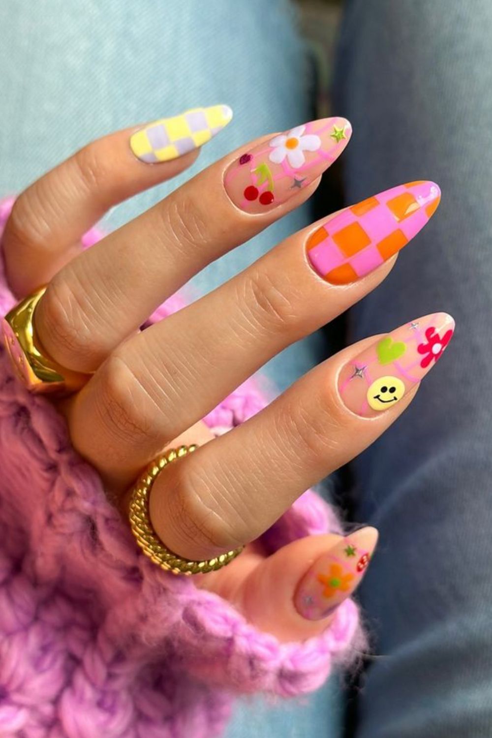 Checkerboard nails with playful smiley and floral designs