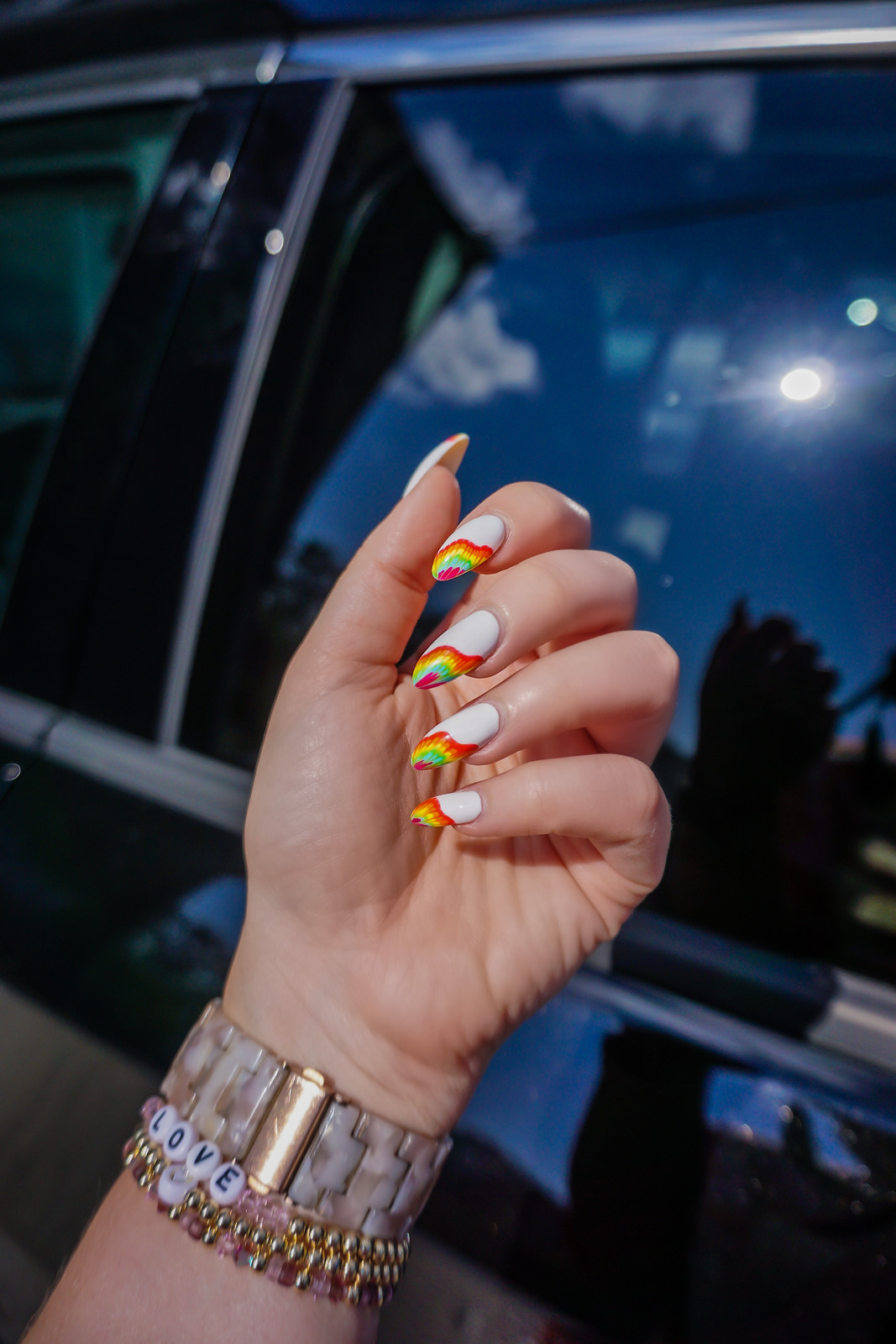 Rainbow flame tips on white nails, bold and vibrant