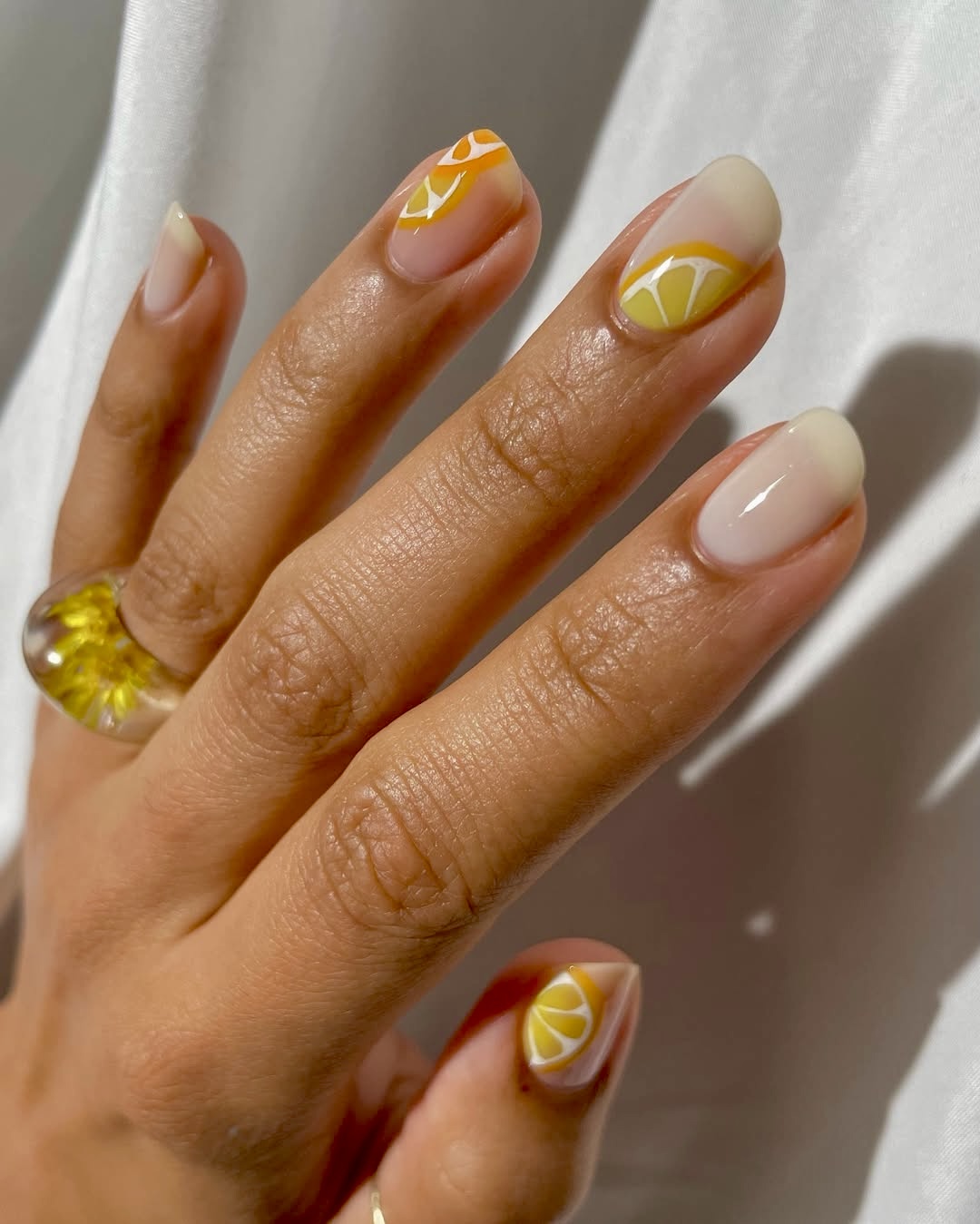 Citrus slice nail art on nude nails