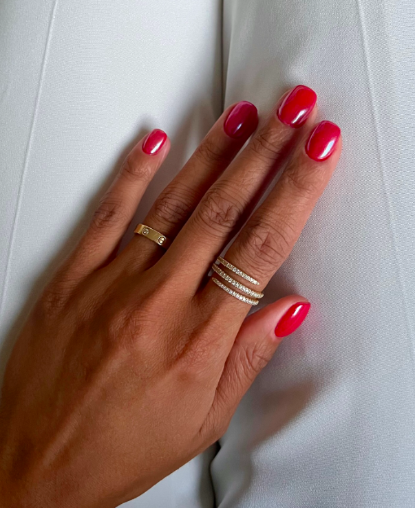 Bold red glossy nails with a rounded shape