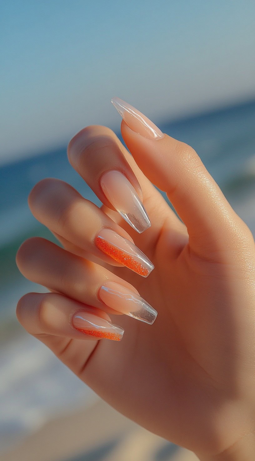 Clear tips with orange glitter on coffin nails