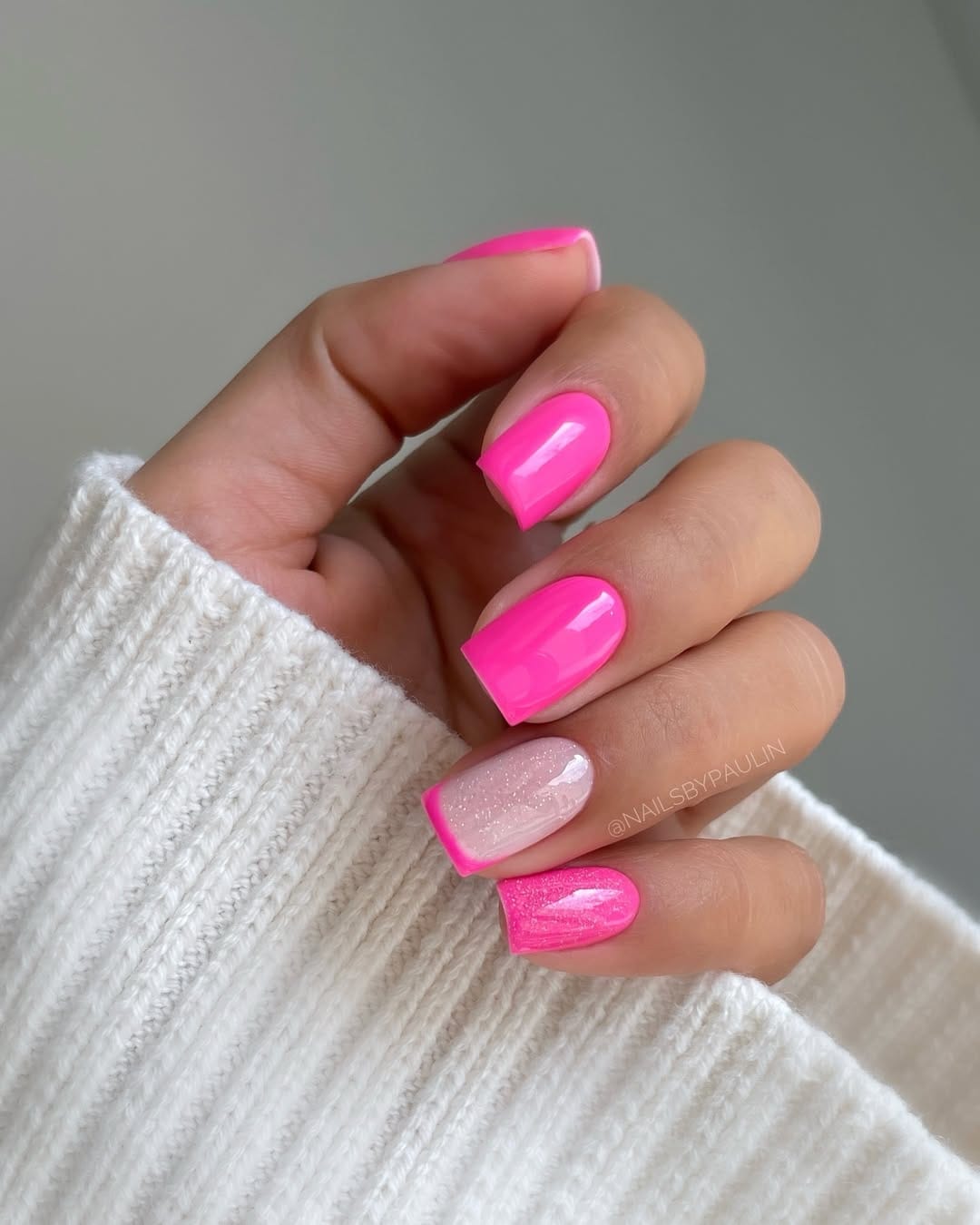 Bright neon pink nails with a glossy finish