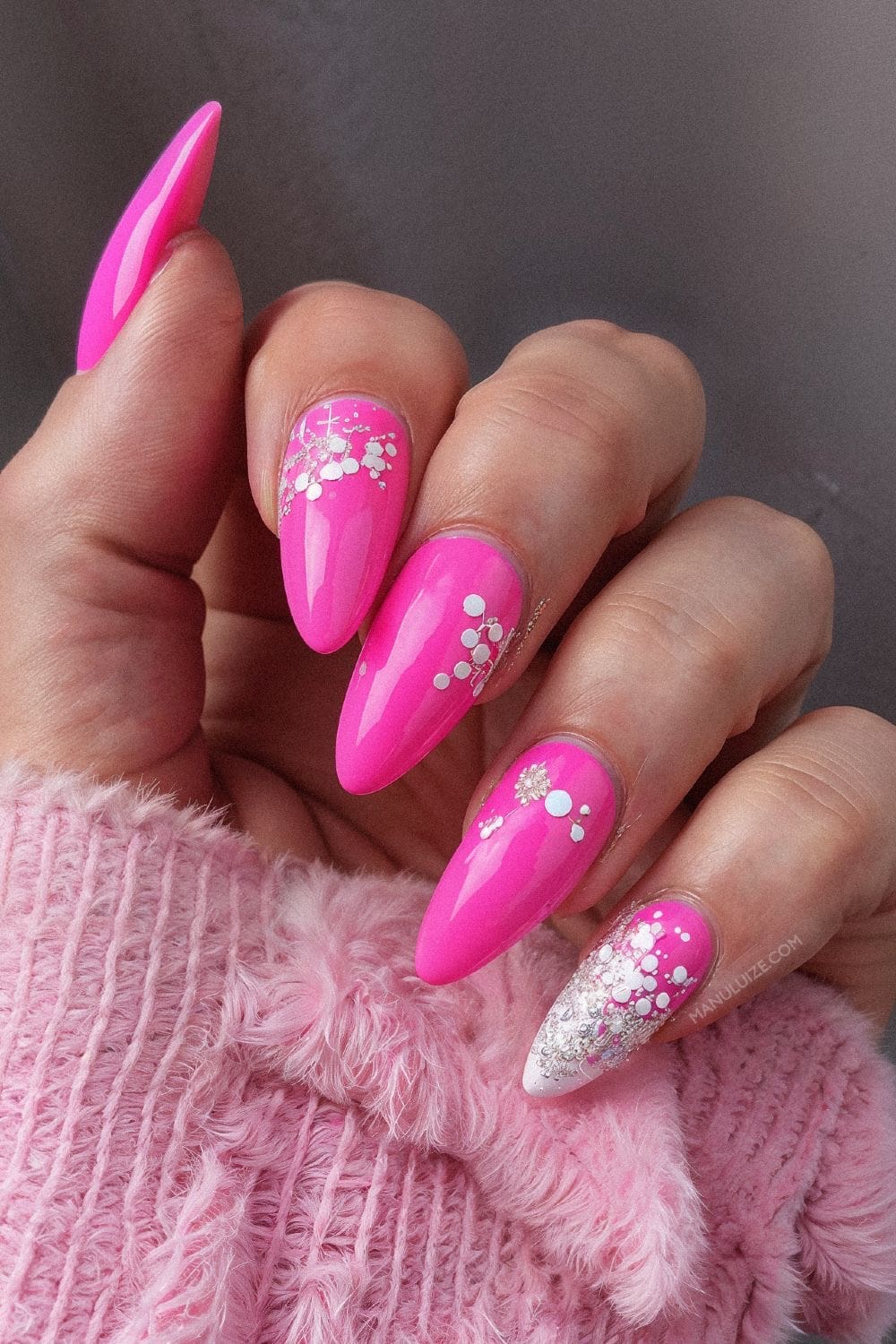 Sparkling hot pink nails with glitter accents