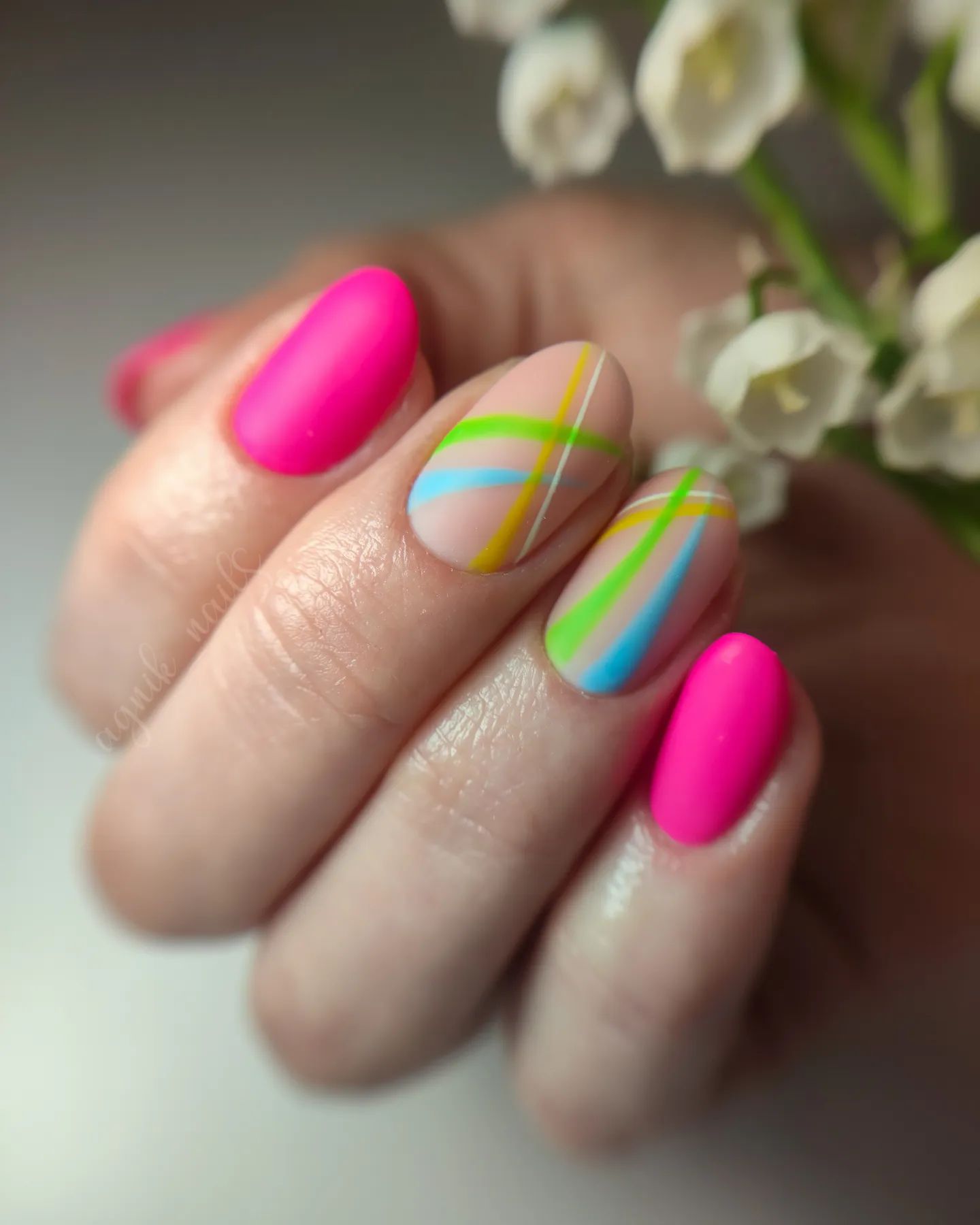 Bright pink nails with geometric line designs