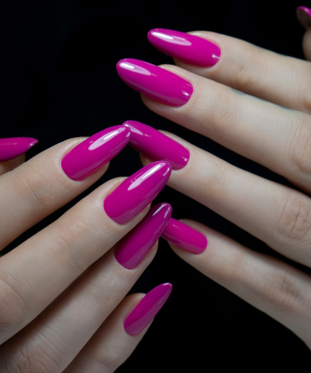 Glossy hot pink nails in almond shape