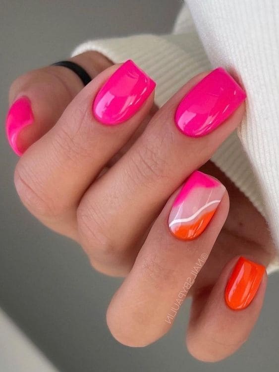 Vibrant pink and orange nails with glossy finish