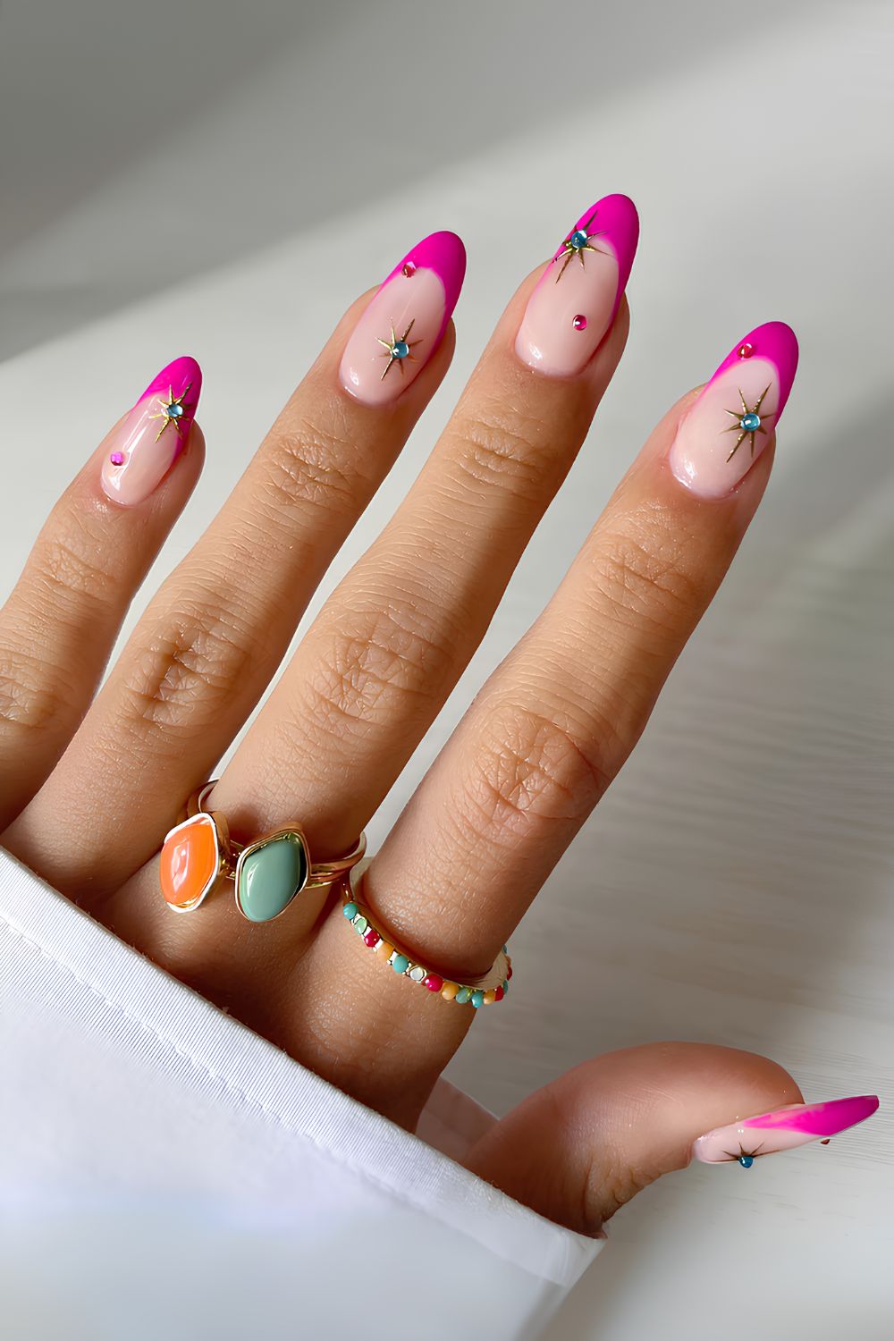 Pink nails with star accents and glossy finish