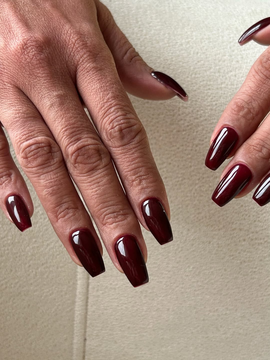 Dramatic burgundy nails with a glossy finish, capturing opulence and elegance for evening wear.