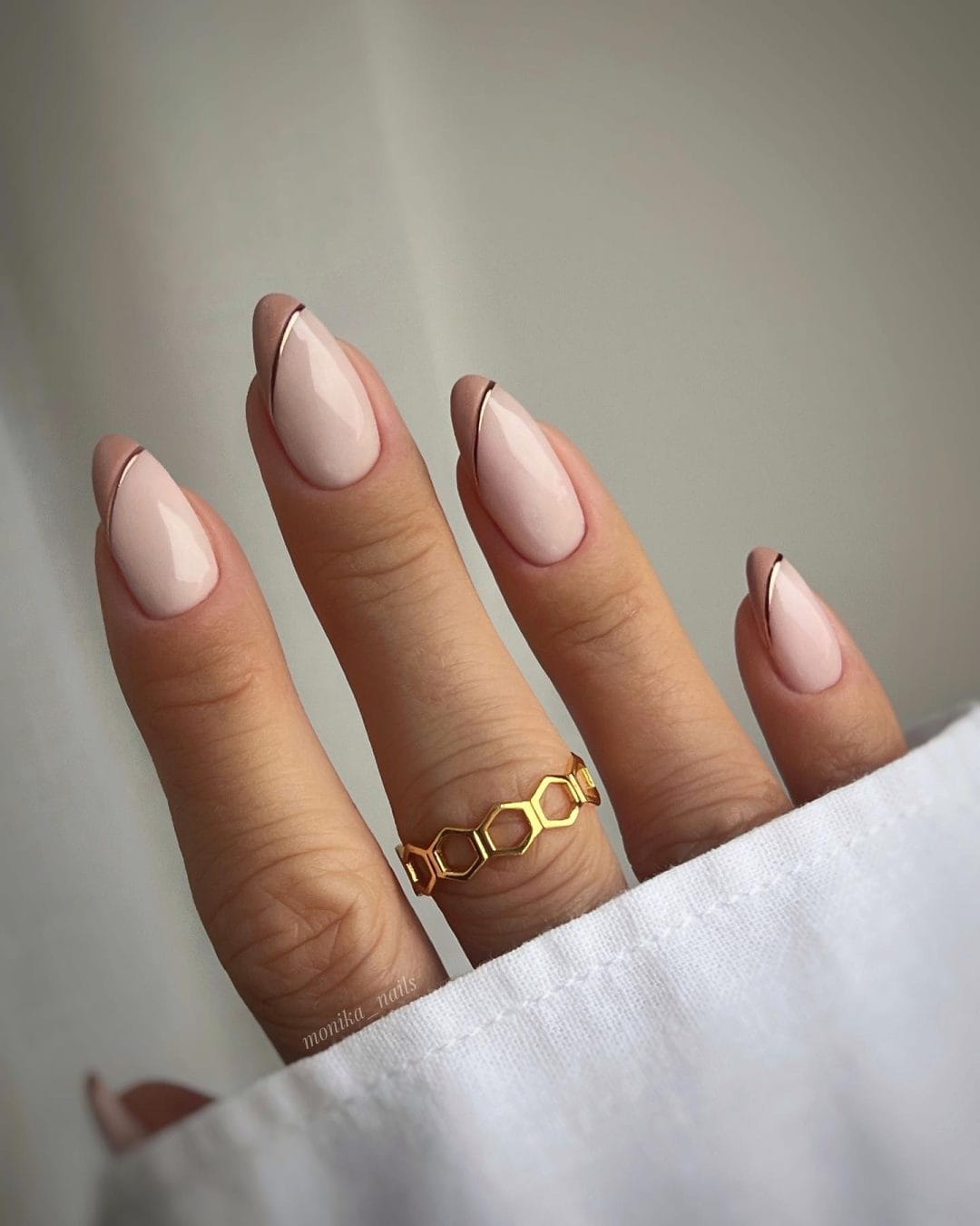 French nails with metallic tips, blending classic and contemporary for a refined look.