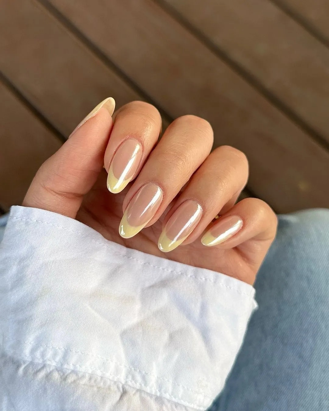 Nails with delicate yellow tips, reminiscent of spring, adding a fresh touch to classic French style.