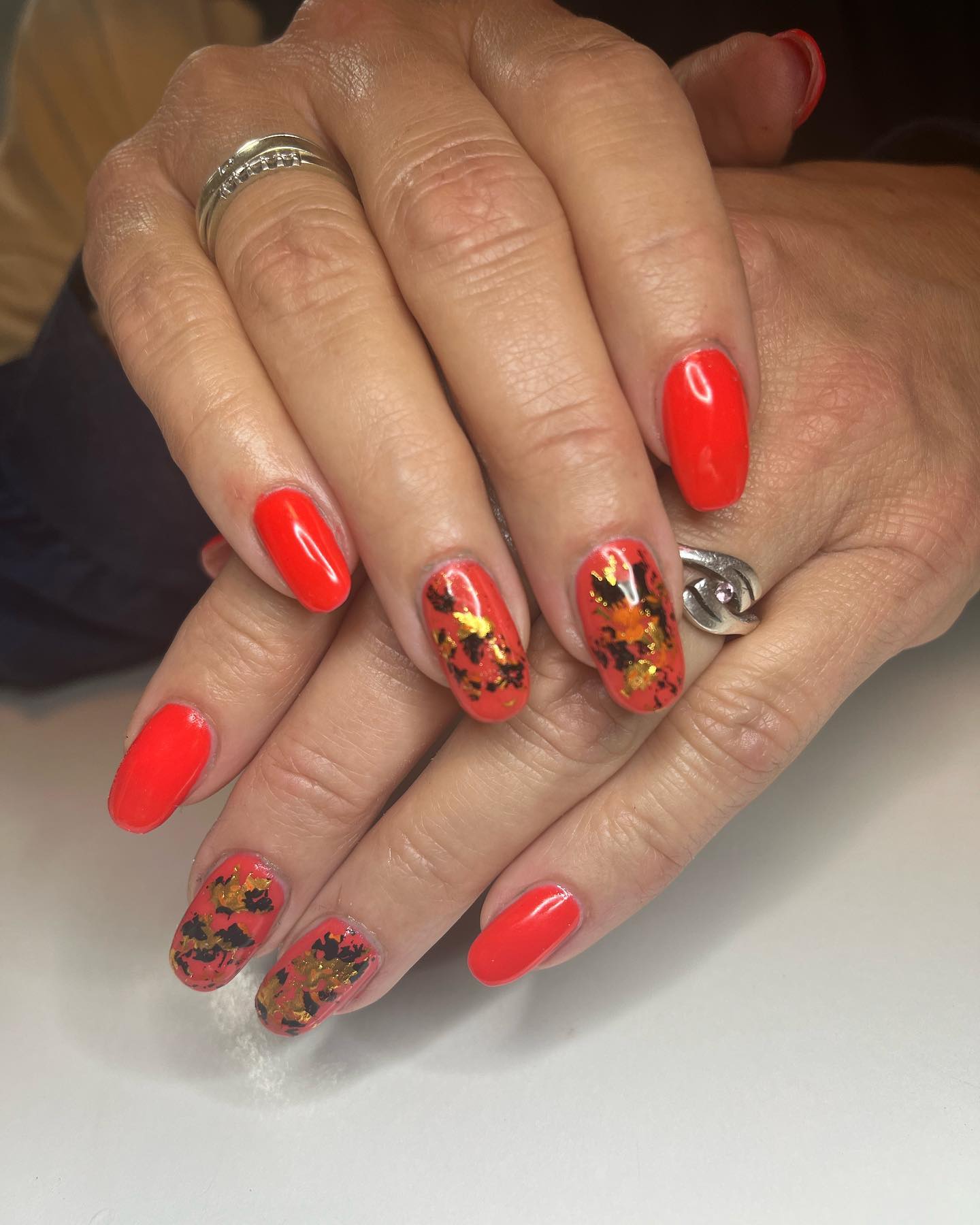Orange and gold autumn leaf nail design