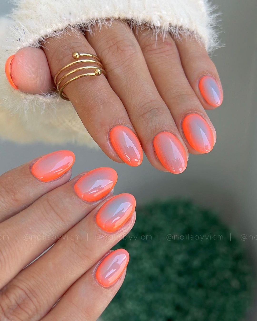 Glossy coral nails with an orange edge