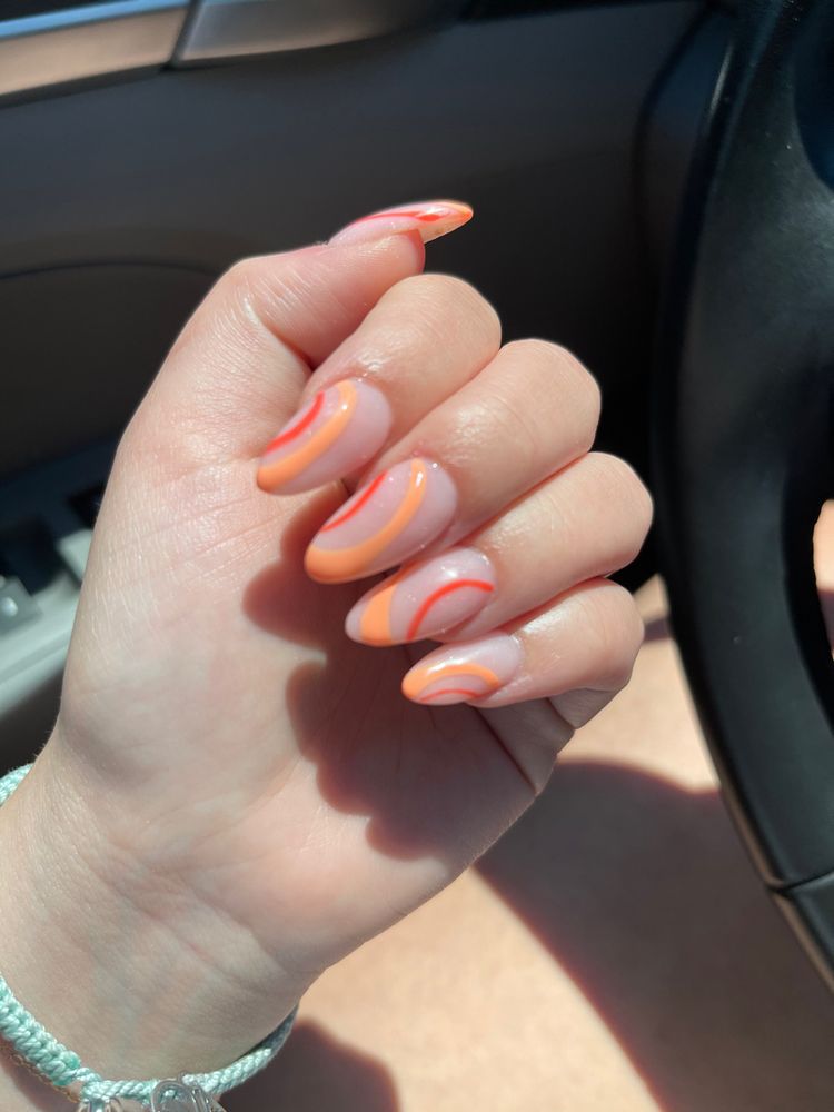 Orange swirl nail design with a sunset vibe