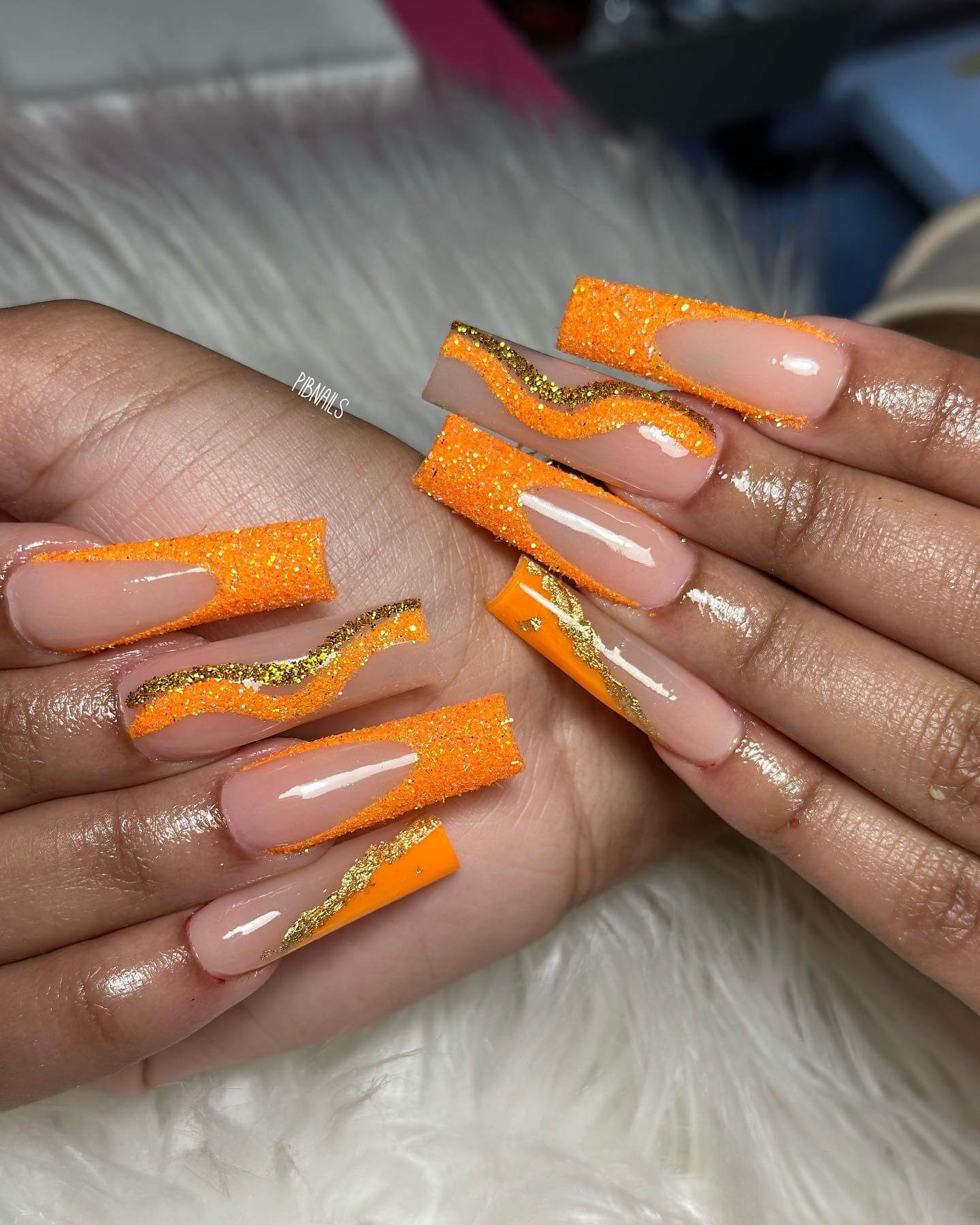Orange glitter wave design with gold accents
