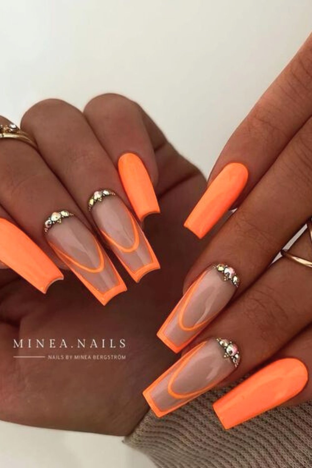 Orange nails with jewel accents