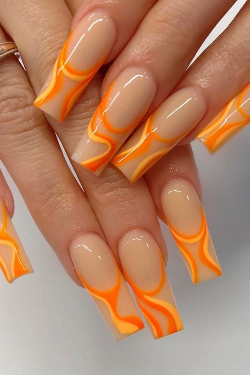 Long nails with orange swirl design