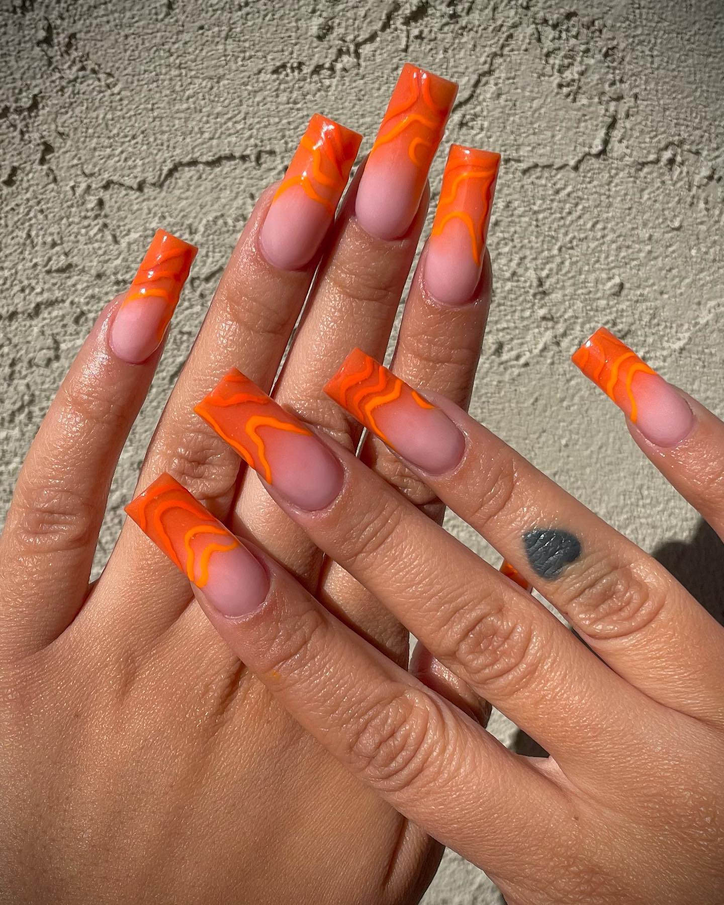 Long nails with orange retro wave design