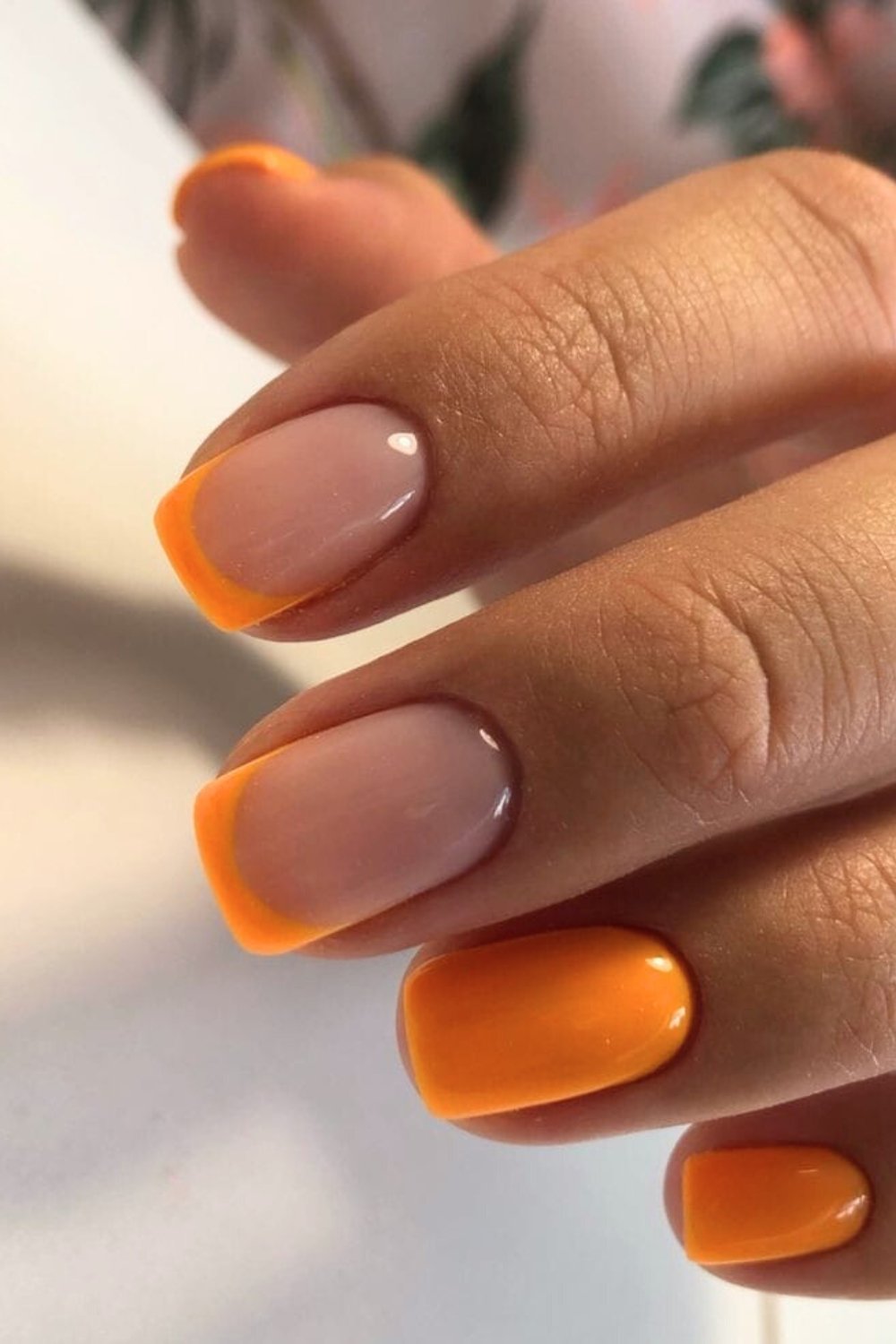 Glossy orange French tip nails
