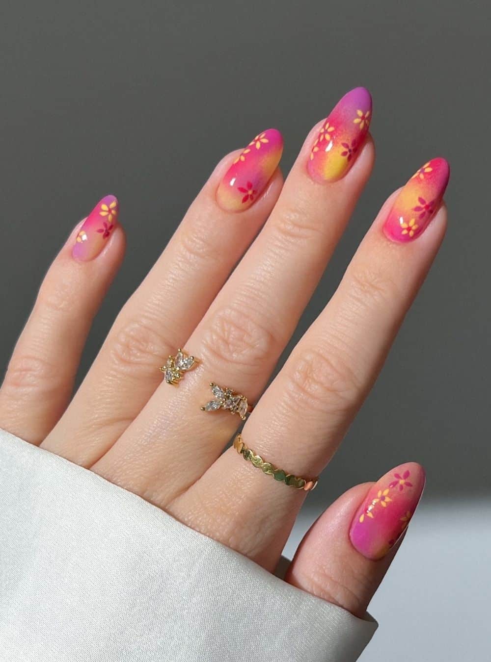 Pink and orange nails with floral accents