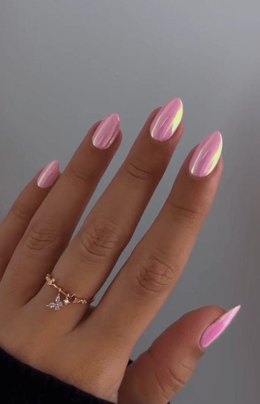 Shimmering iridescent pink nails reflecting light and Pinterest aesthetics.