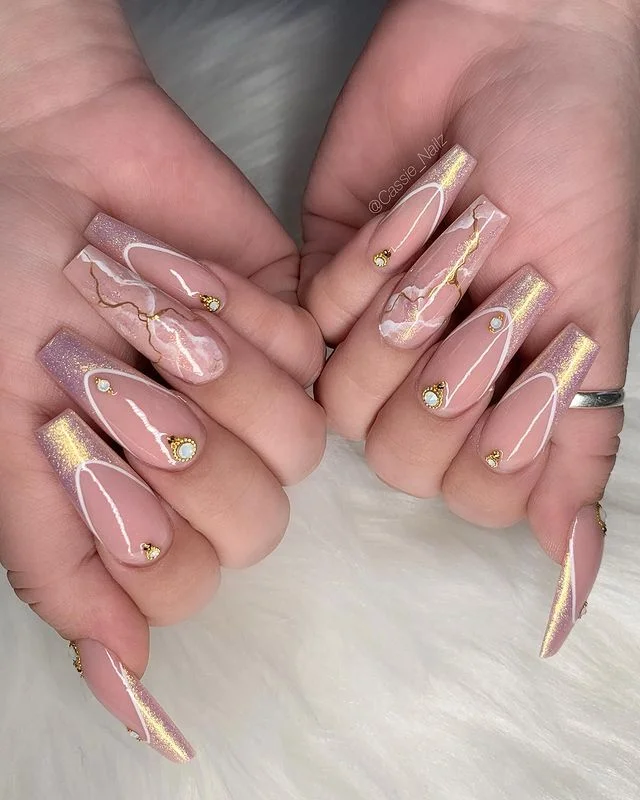 Marble nails with gold accents, Pinterest artistry.
