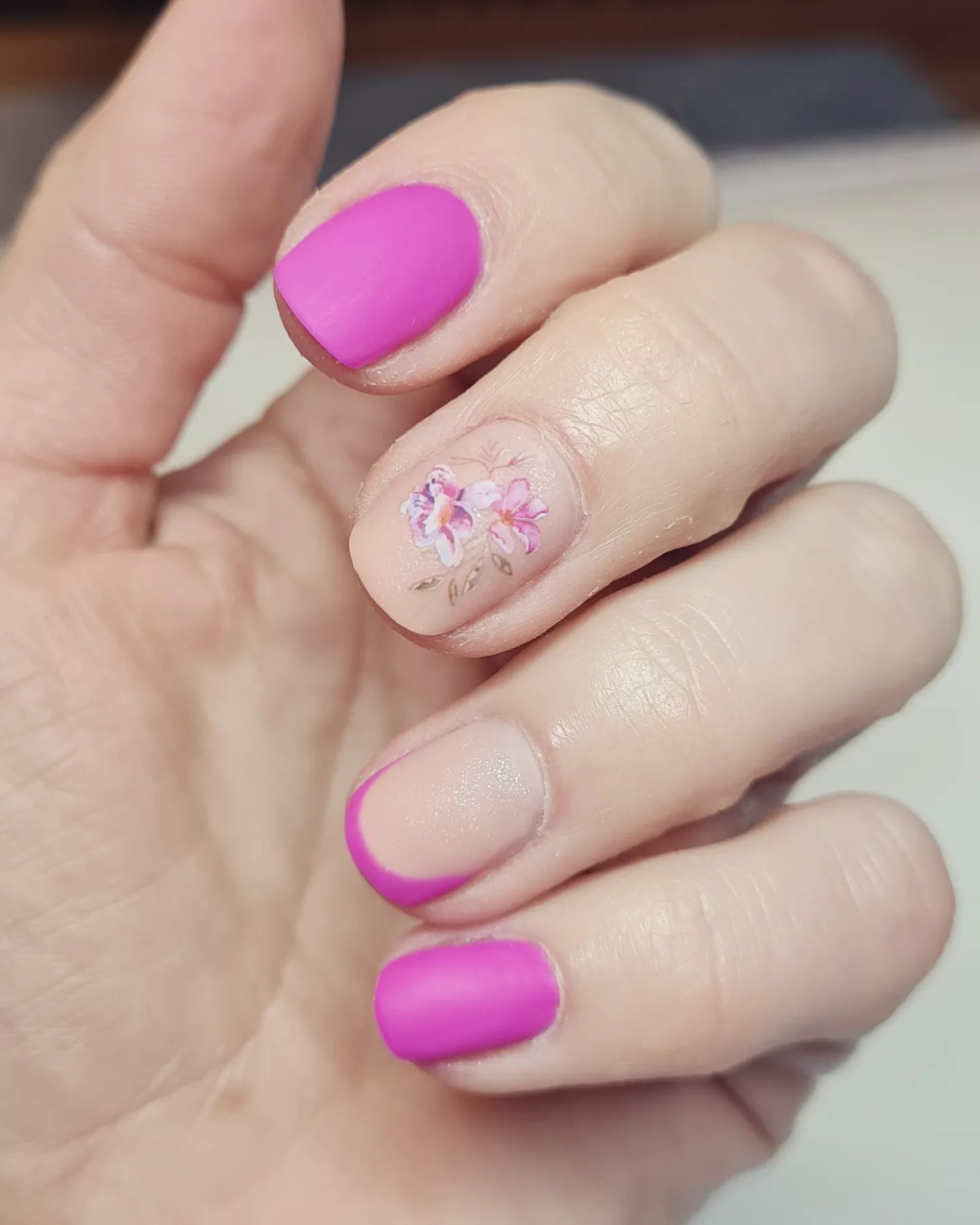 Matte pink nails with floral accent, Pinterest elegance.