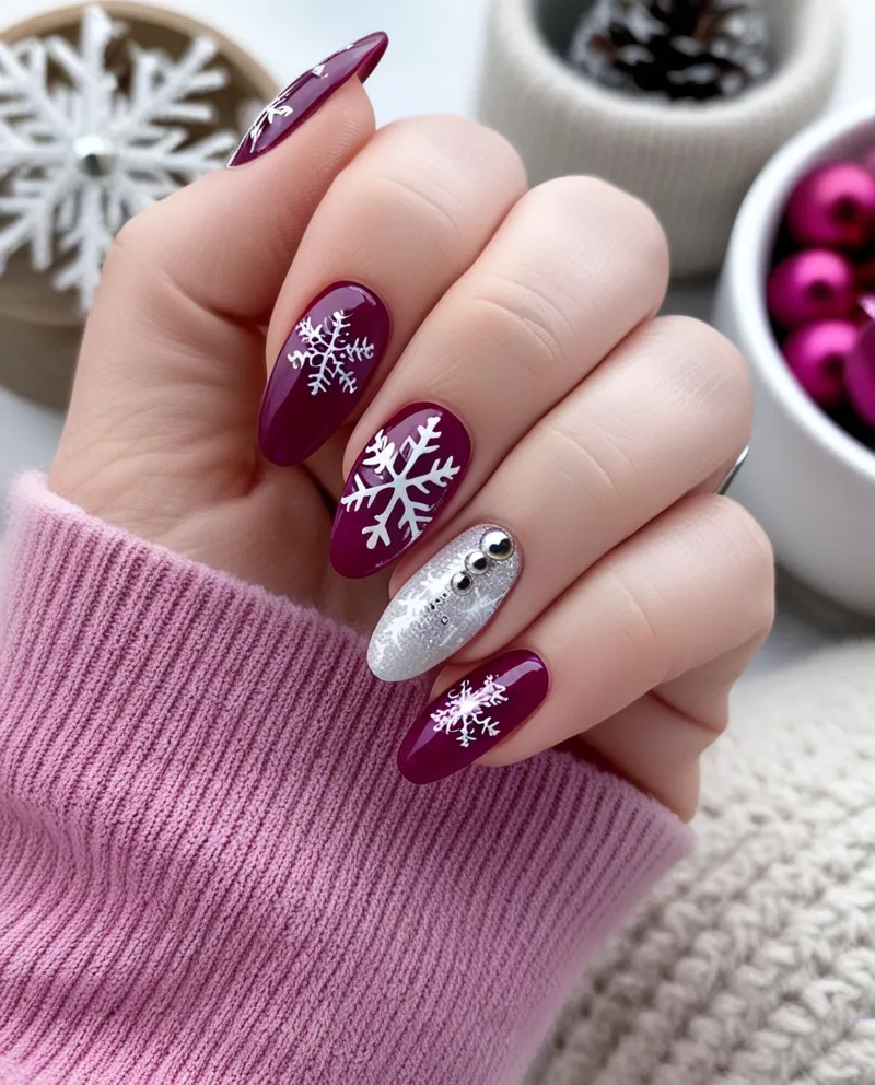 Berry nails with snowflake art and accent nail.