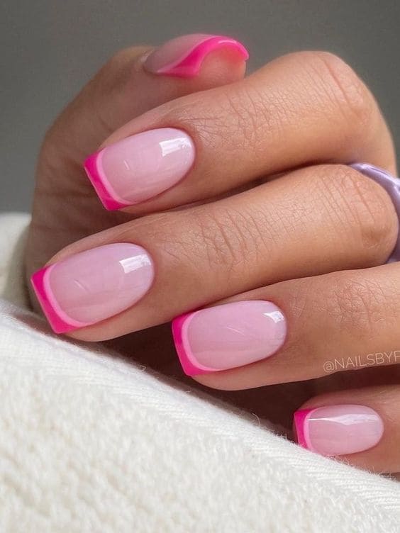 Neon pink French tips on square nails.