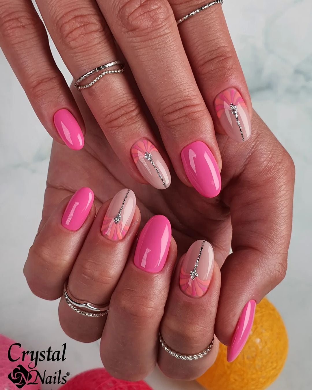 Geometric pink and nude nails with glossy finish.