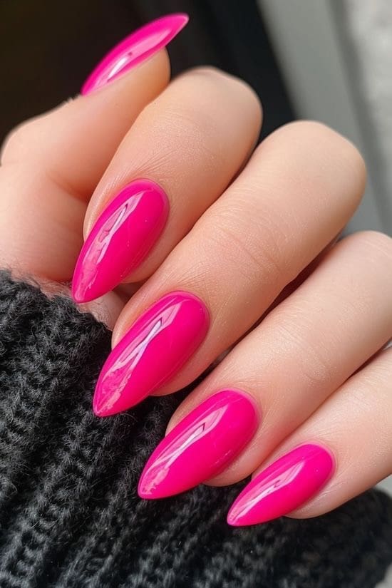 Neon pink stiletto nails with high gloss.