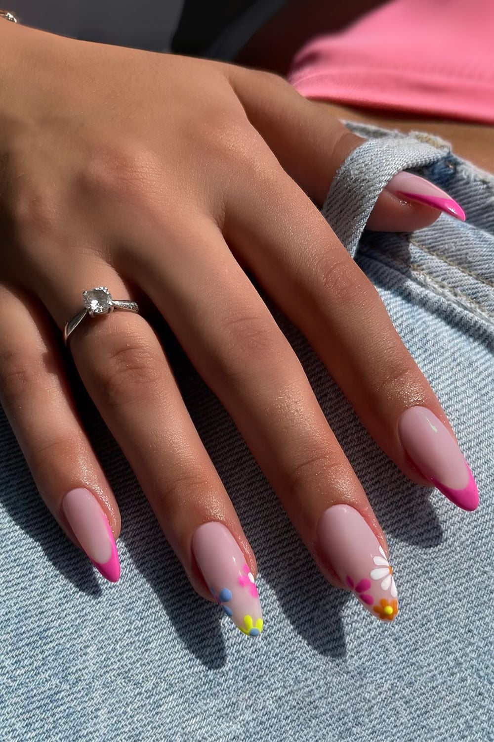 Natural pink nails with floral tips on almond shape.