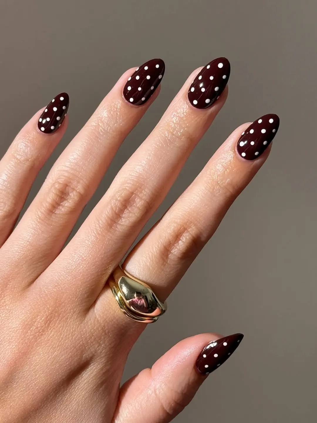 Burgundy nails with white polka dots