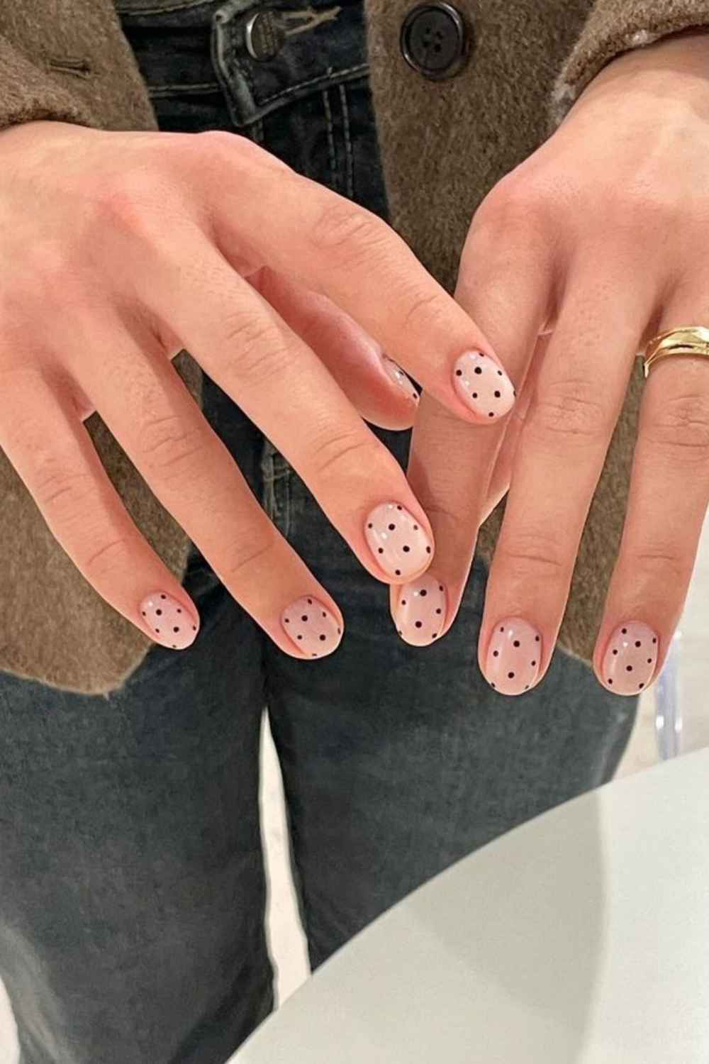 Nude nails with black polka dots