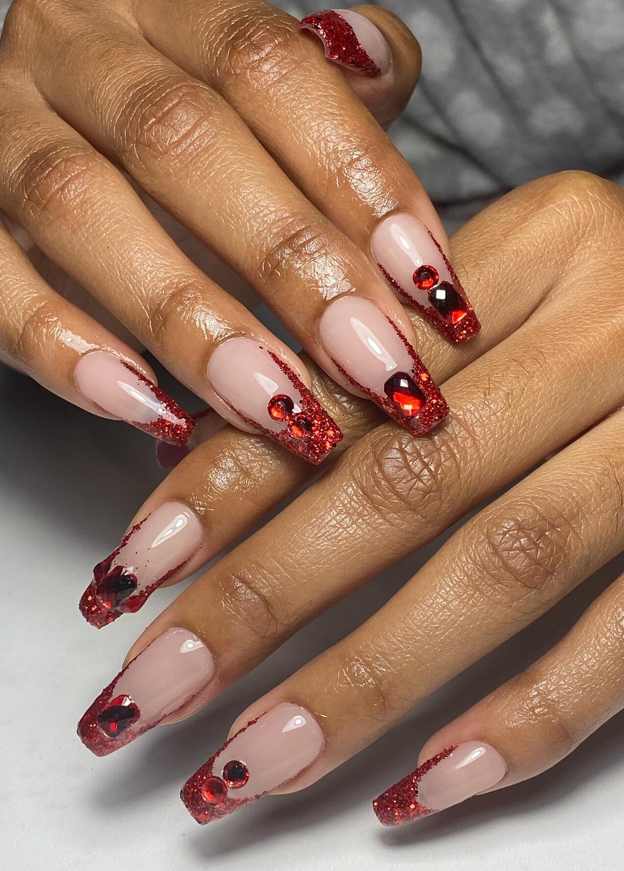 Red glitter French tips with rhinestones, Pinterest festive nails.