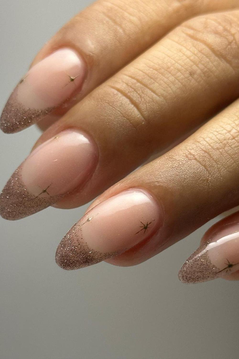 Subtle glitter French tips on almond nails, Pinterest elegant nails.