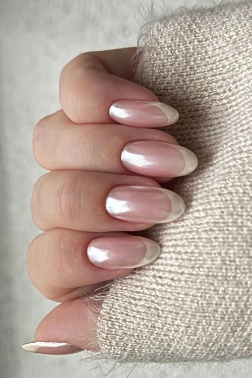 Pearl white French tips on oval nails.