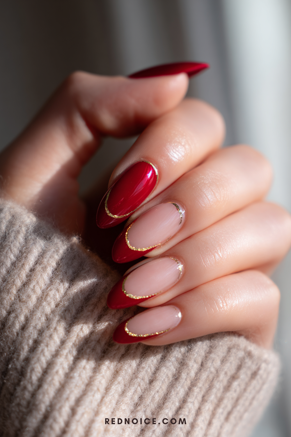 Red and gold French tips on almond nails.