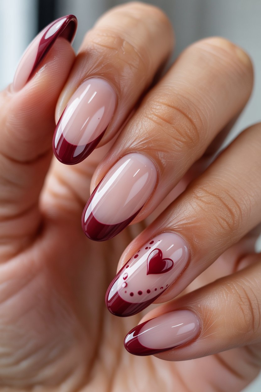 Red heart French tips on almond nails.