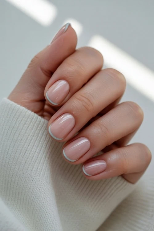 Silver French tips on short oval nails.