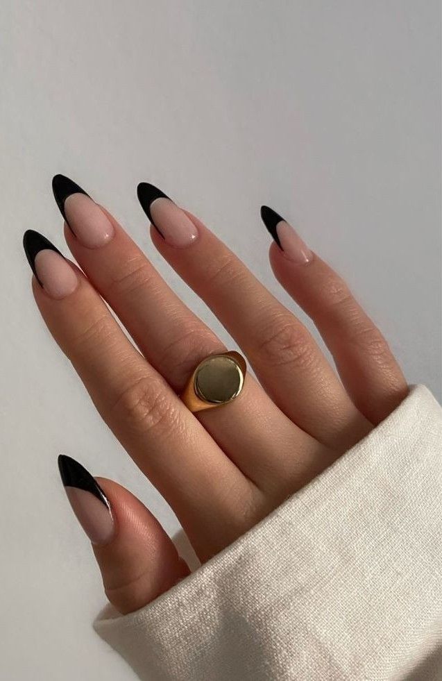 Black French tips on long stiletto nails.