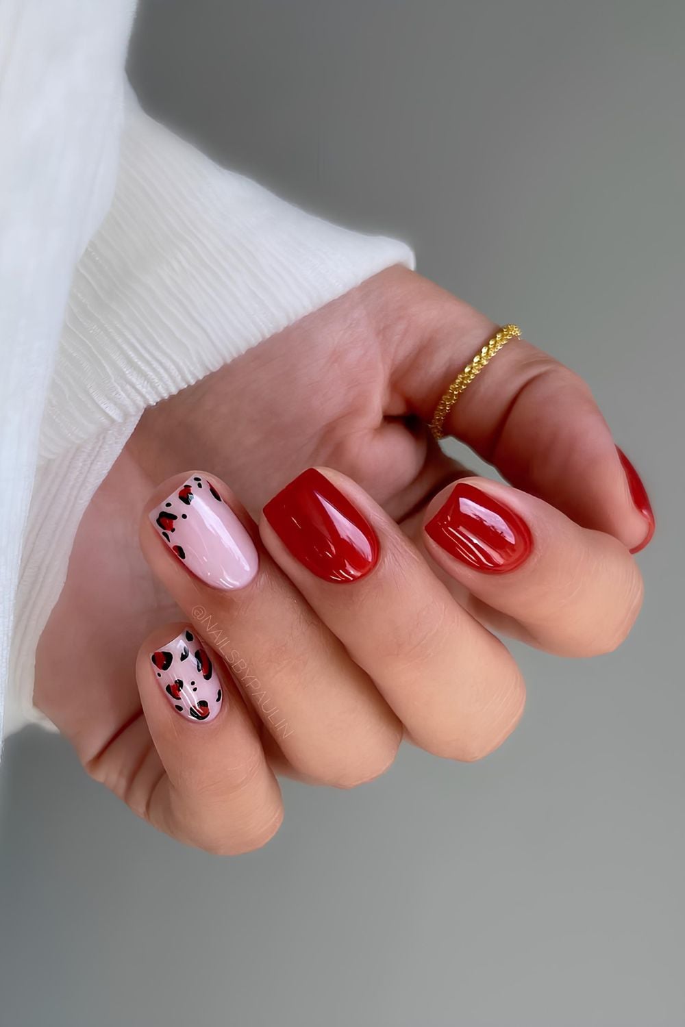 Red French tips with leopard accent on medium square nails.