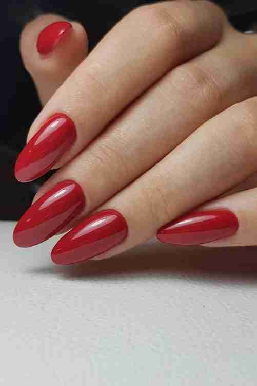 Classic glossy red nails in almond shape