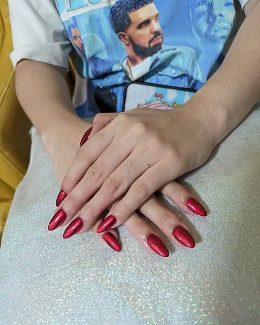 Metallic red nails in almond shape