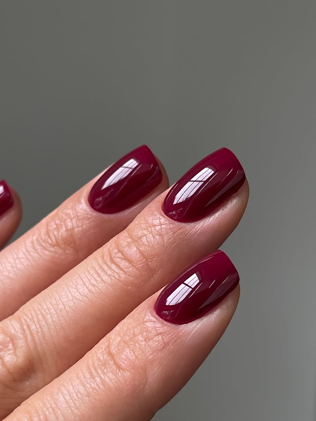 Deep burgundy nails with short length