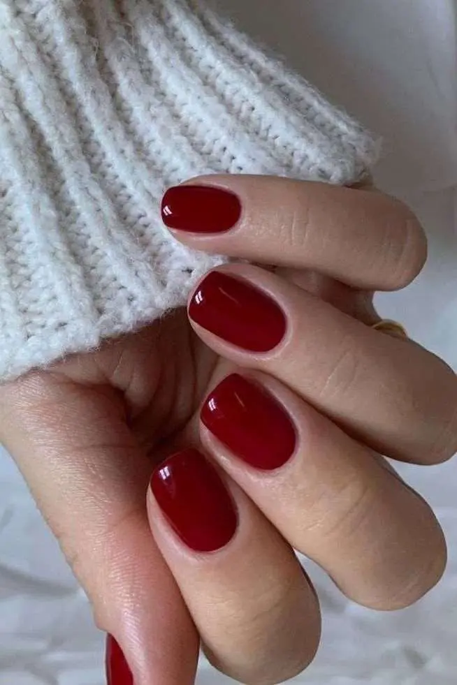 Deep red nails with short round shape